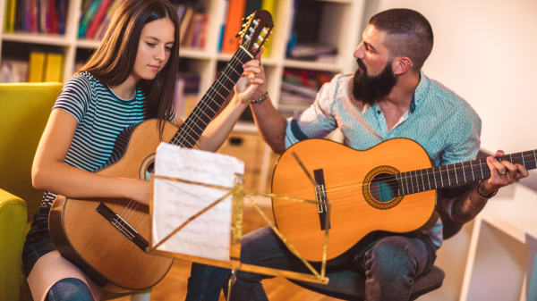 Guy and girl playing guitar