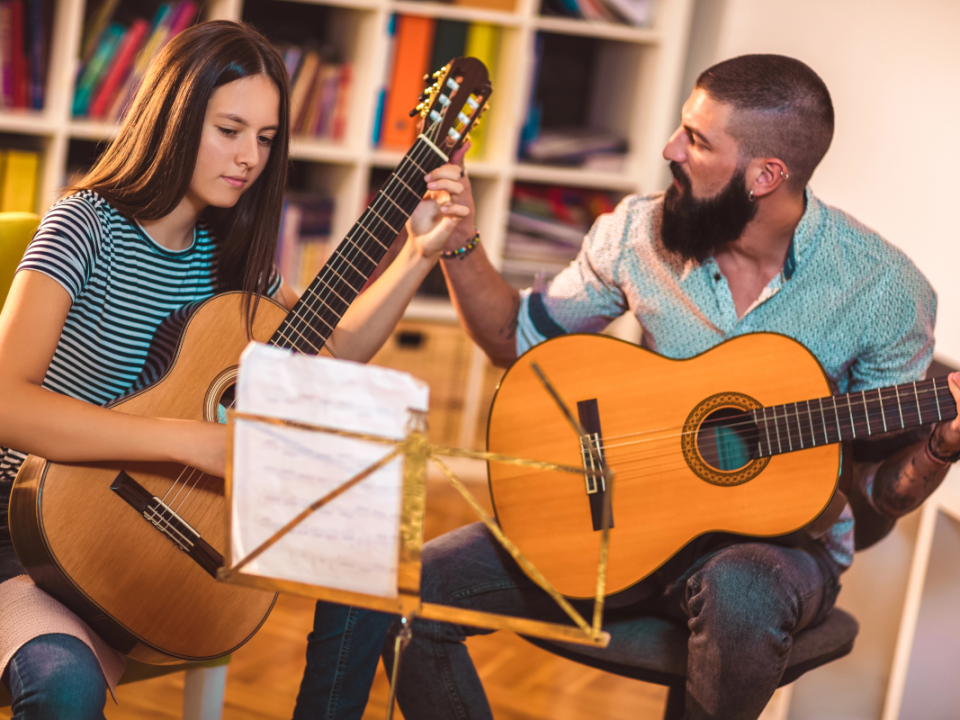 Guy and girl playing guitar