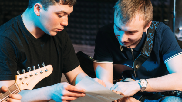 Two men looking at sheet music