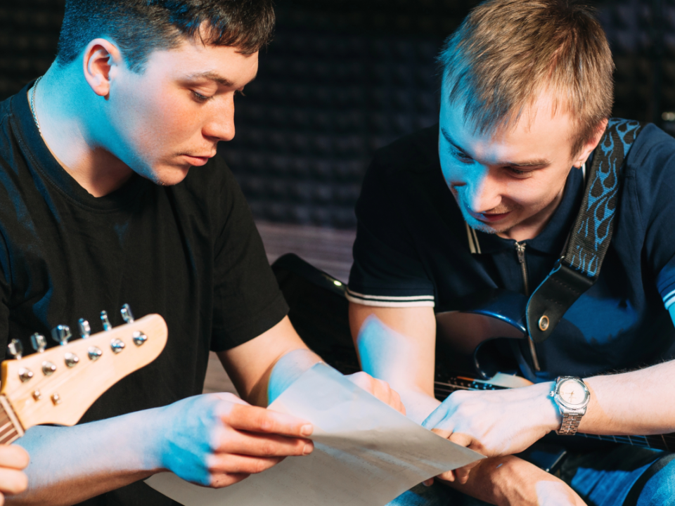 Two men looking at sheet music